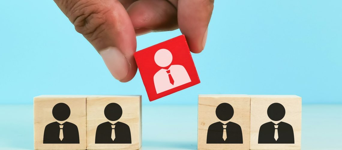 choosing good employee leader. Man choose and take wooden cube.